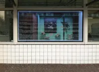 A Photo of a Photo in a Display Case in a Museum in a Display Window